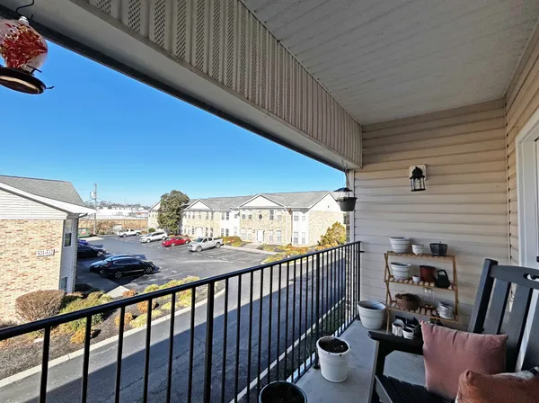 a view of a balcony with chairs