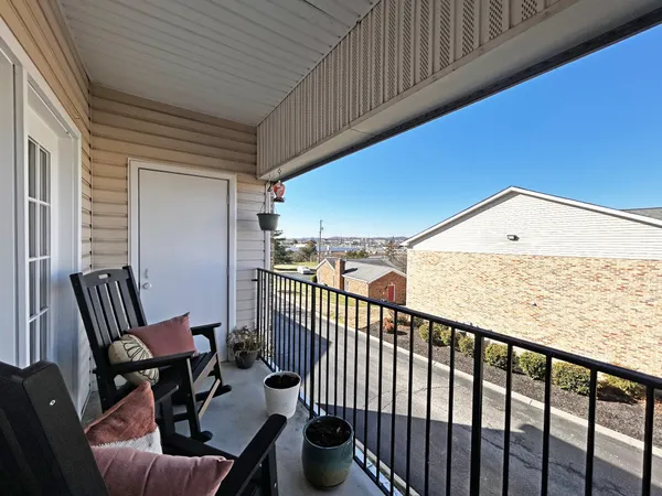 a view of a balcony with furniture