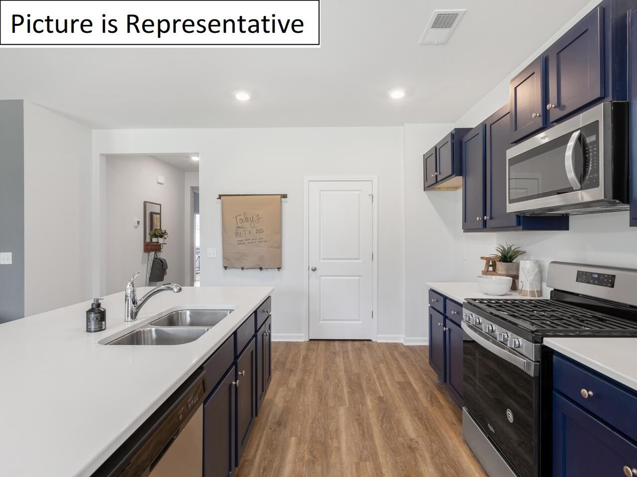 1120 Secrest Cmns Drive Monroe, NC 28112 - Photo 11 of 25 a kitchen with a sink stove top oven and cabinets