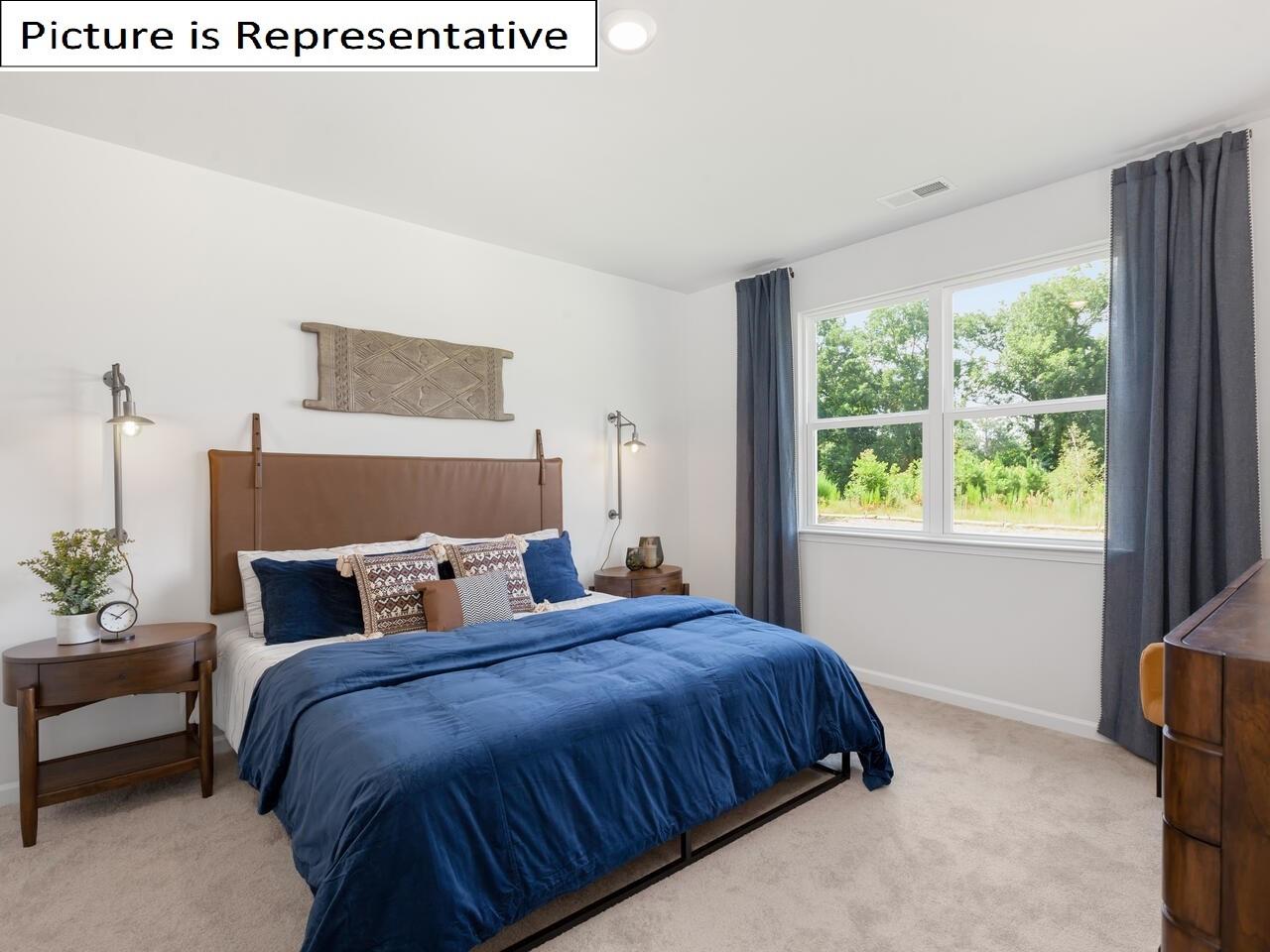 1120 Secrest Cmns Drive Monroe, NC 28112 - Photo 19 of 25 a bedroom with a large bed and a window