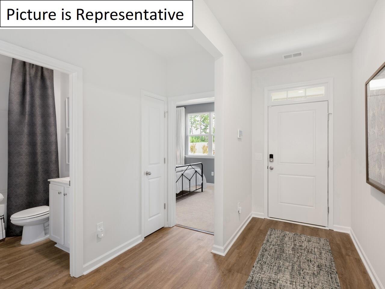 1120 Secrest Cmns Drive Monroe, NC 28112 - Photo 3 of 25 a view of an empty room with wooden floor and a bathroom