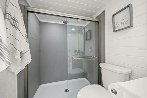 a bathroom with a toilet and a shower