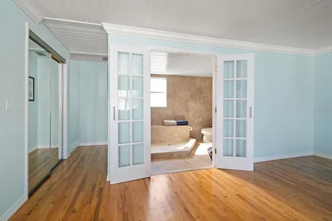 a view of a room with wooden floor and a window