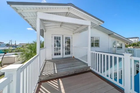 a view of a house with wooden deck