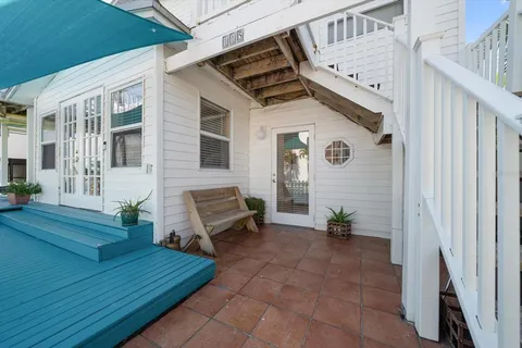 a view of a patio with table and chairs with wooden floor and plants