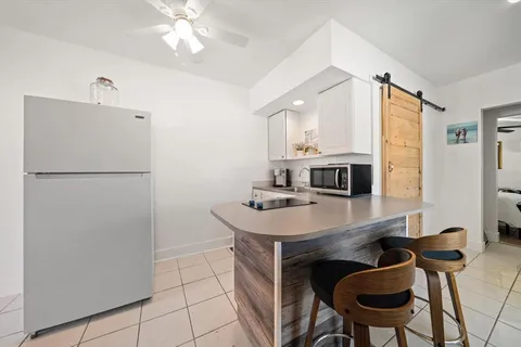 a kitchen with a table and chairs