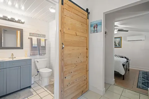 a bathroom with a granite countertop sink a toilet and shower