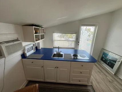 a kitchen with cabinets appliances and a window