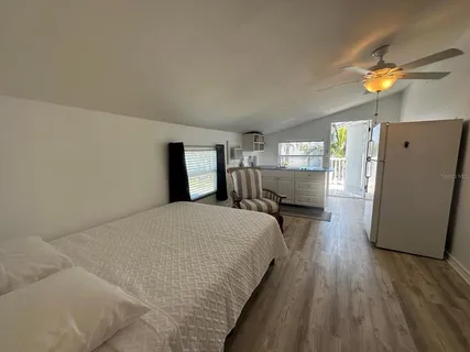 a bed room with a bed furniture and a large window