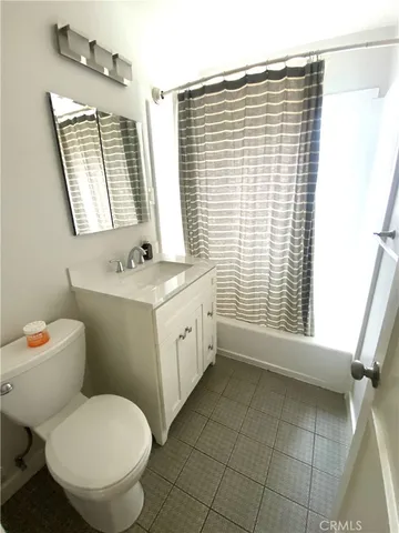 a front view of a house with a tree