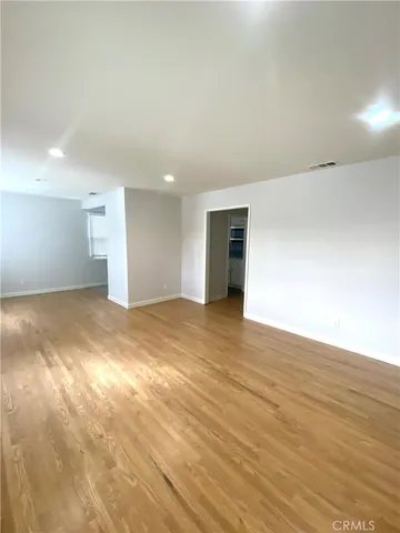 a view of an empty room and wooden floor