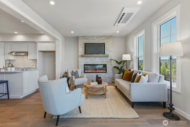 a living room with fireplace furniture and a flat screen tv