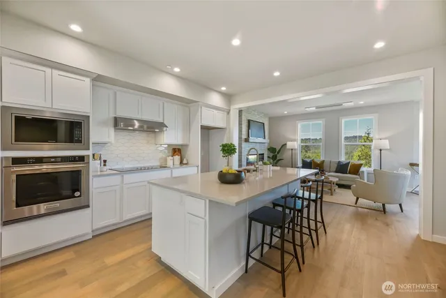 a kitchen with appliances a sink a counter top space and cabinets
