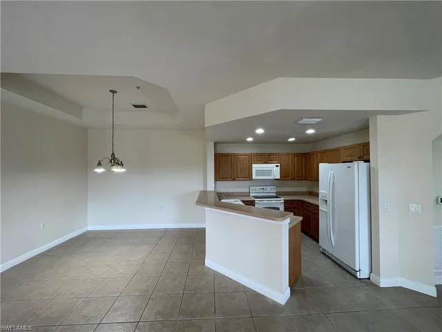 a kitchen with stainless steel appliances a refrigerator a stove a microwave and a refrigerator