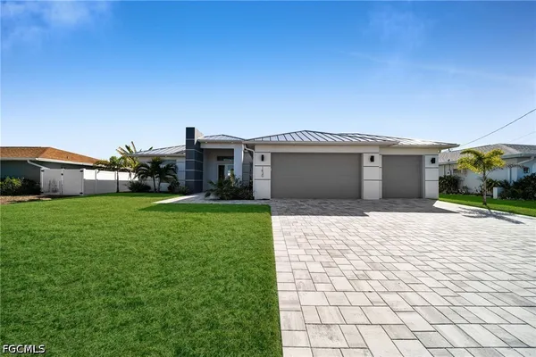 a view of a house with a garden and pathway