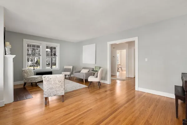 a living room with furniture wooden floor and a window
