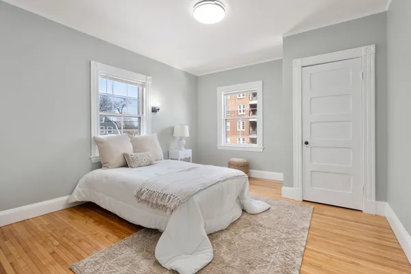 a bedroom with a bed and painting on the wall