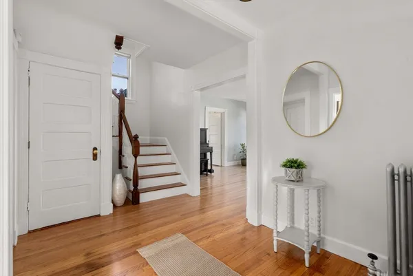 a view of an entryway with wooden floor