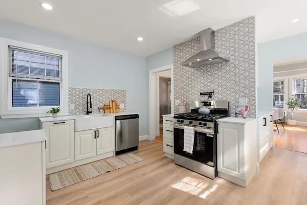 a kitchen with stainless steel appliances granite countertop a stove and a sink