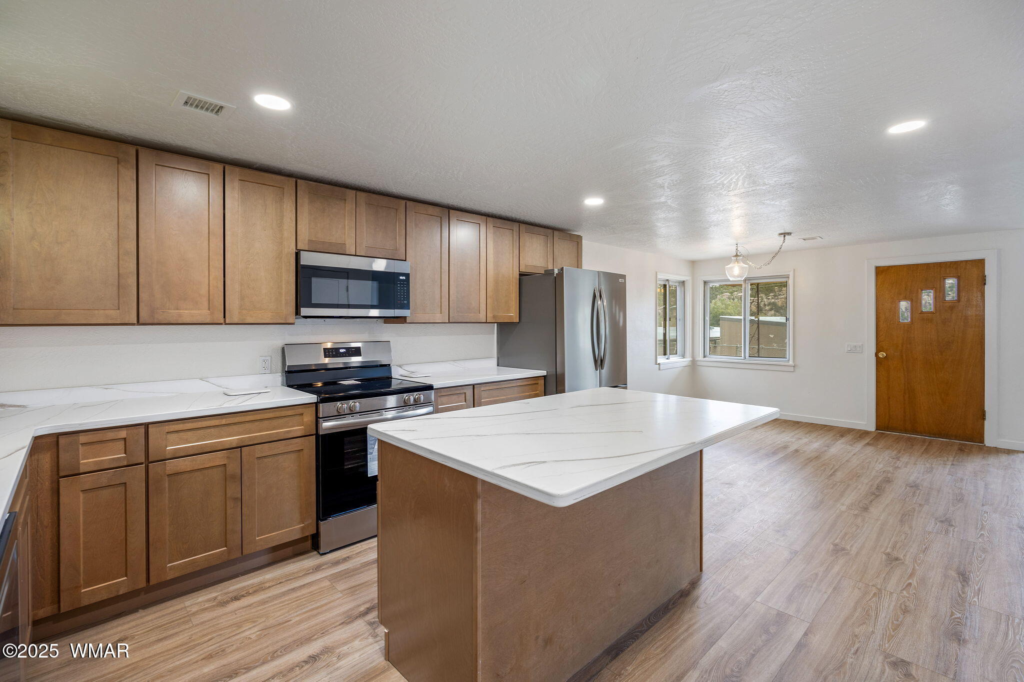 3368 Buckskin Canyon Road Heber, AZ 85928 - Photo 12 of 48 a kitchen with stainless steel appliances granite countertop a sink stove refrigerator and cabinets