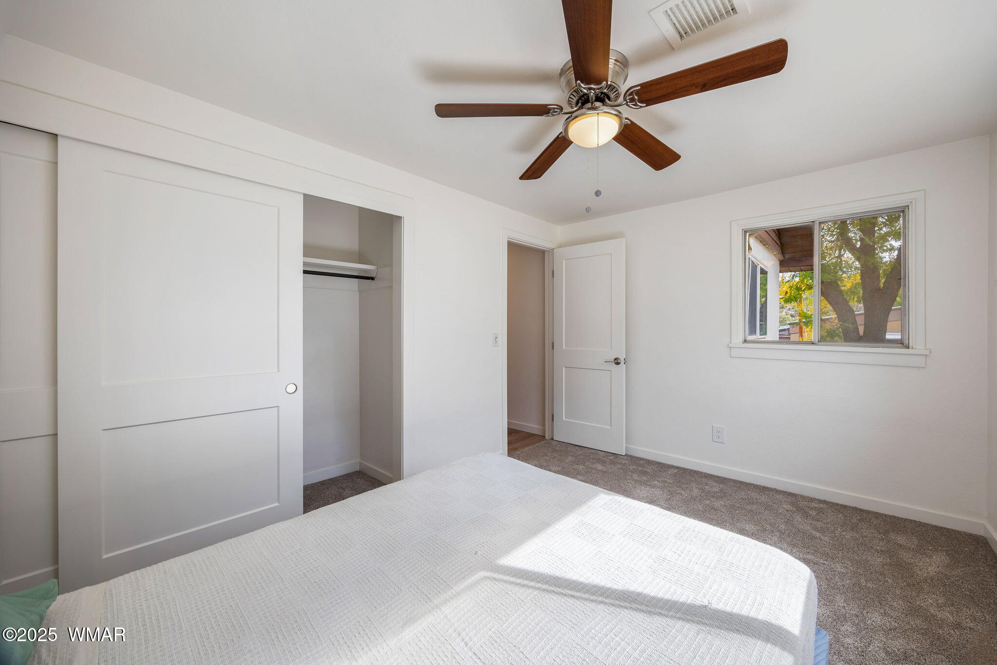 3368 Buckskin Canyon Road Heber, AZ 85928 - Photo 14 of 48 a bedroom with a bed and a ceiling fan