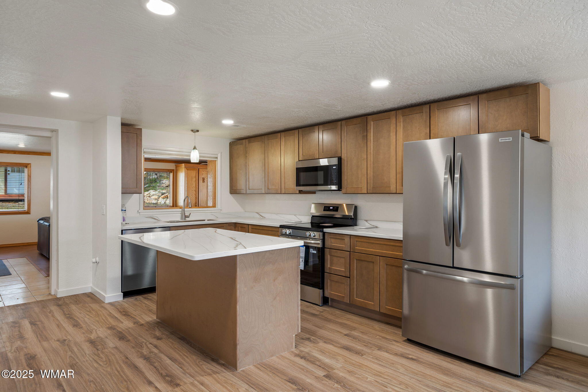 3368 Buckskin Canyon Road Heber, AZ 85928 - Photo 4 of 48 a kitchen with cabinets stainless steel appliances and wooden floor