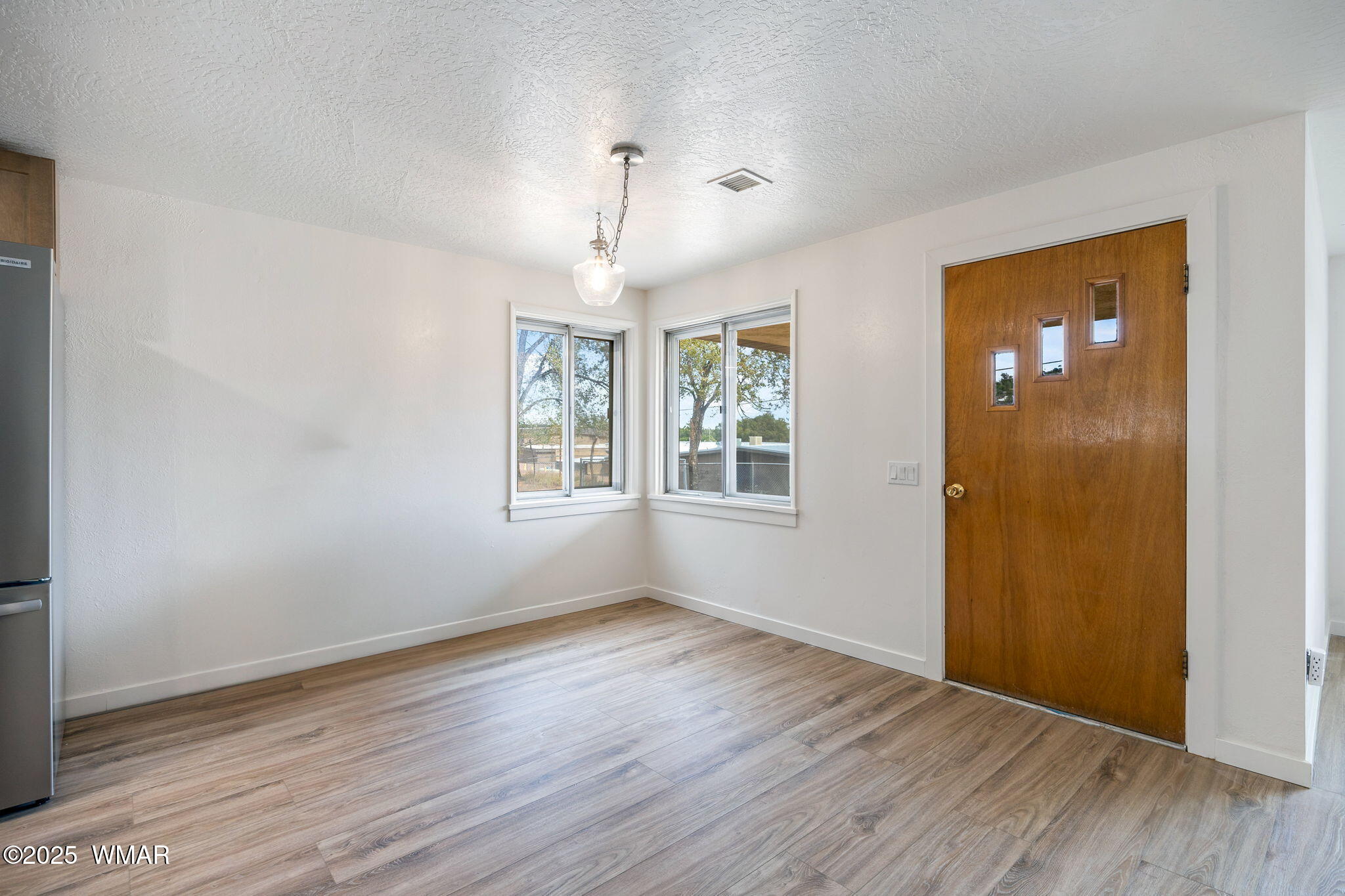3368 Buckskin Canyon Road Heber, AZ 85928 - Photo 5 of 48 an empty room with wooden floor and windows