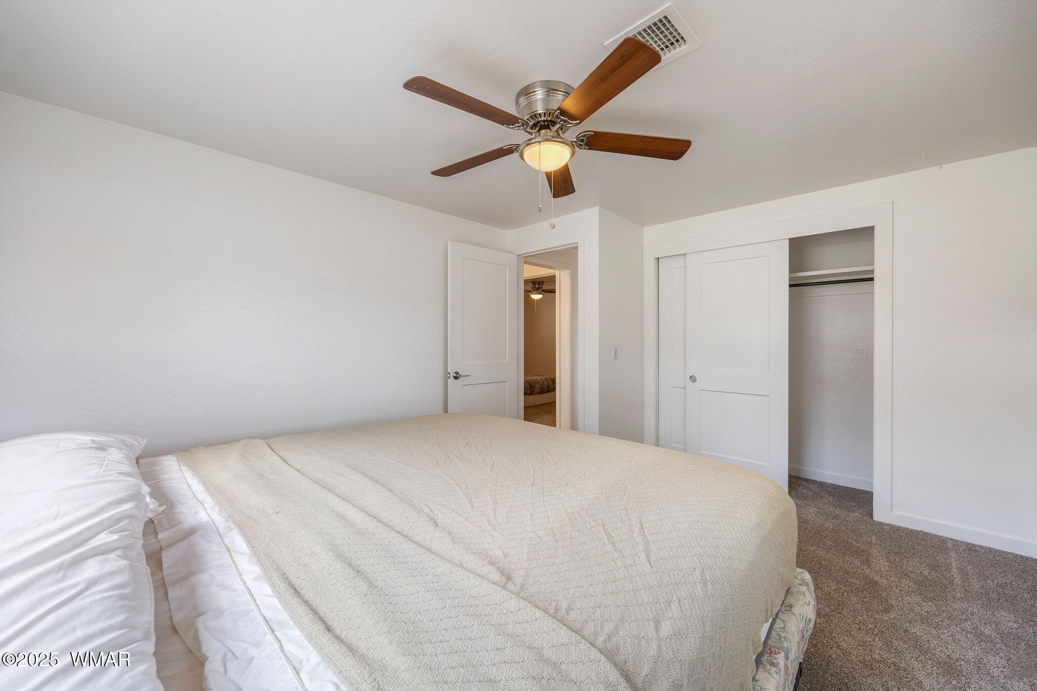 3368 Buckskin Canyon Road Heber, AZ 85928 - Photo 8 of 48 a bedroom with a large bed and a ceiling fan