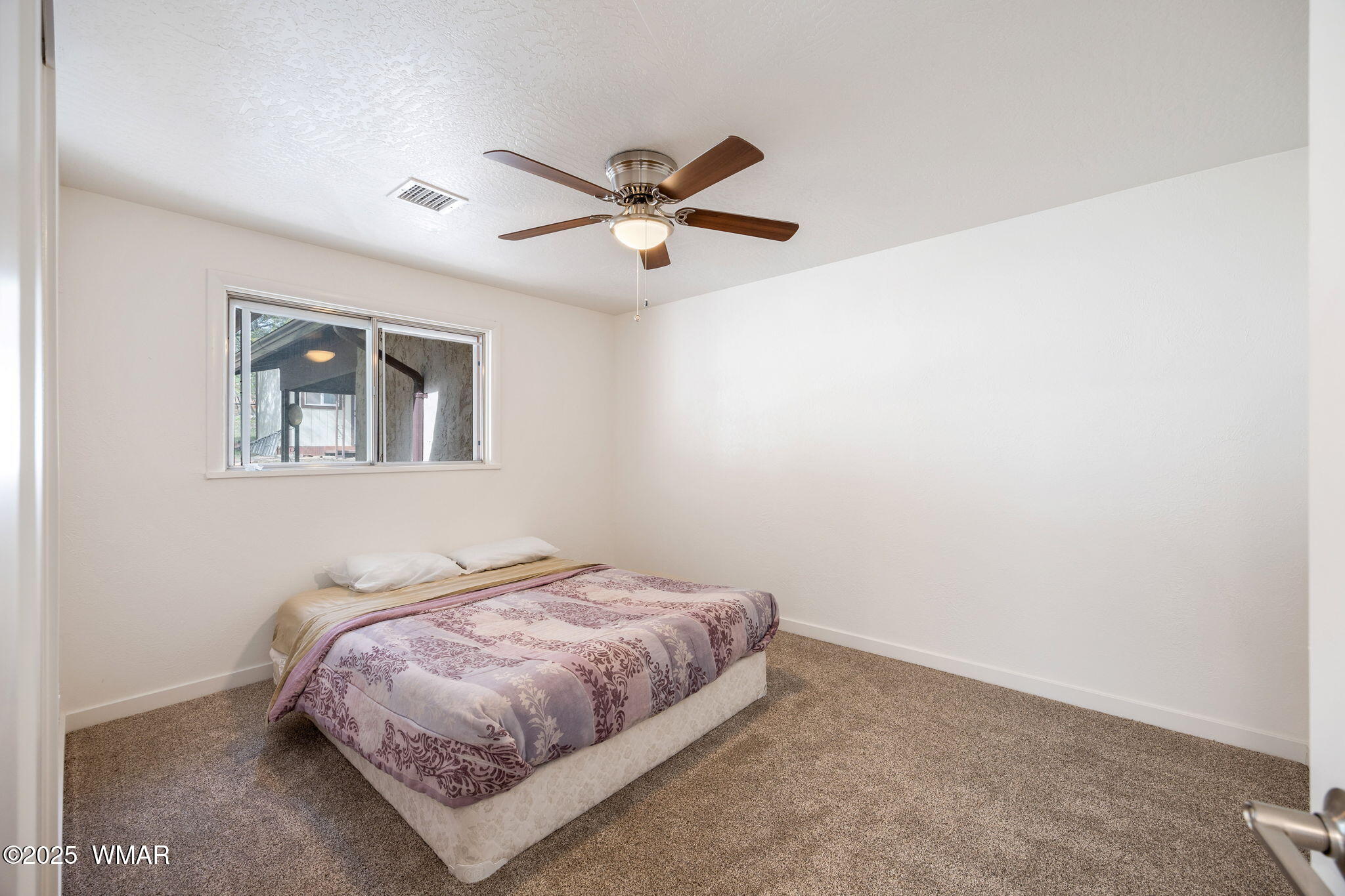 3368 Buckskin Canyon Road Heber, AZ 85928 - Photo 9 of 48 a bedroom with a bed and a painting on the wall