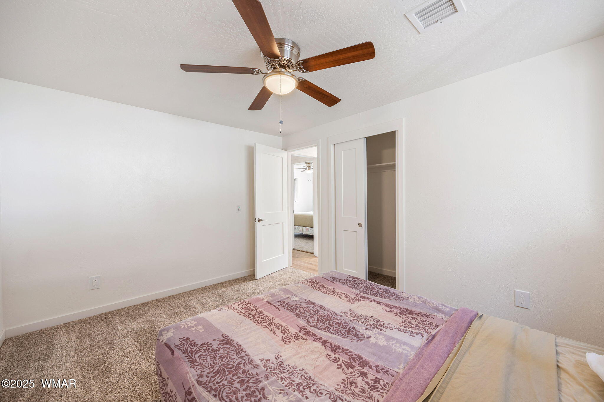 3368 Buckskin Canyon Road Heber, AZ 85928 - Photo 10 of 48 a bedroom with a bed and a chandelier