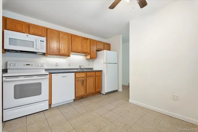 a kitchen with a sink a stove and cabinets