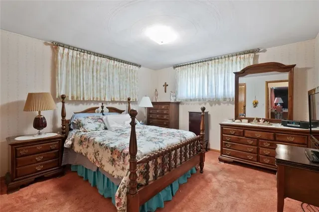 a bedroom with a bed and a dresser in it