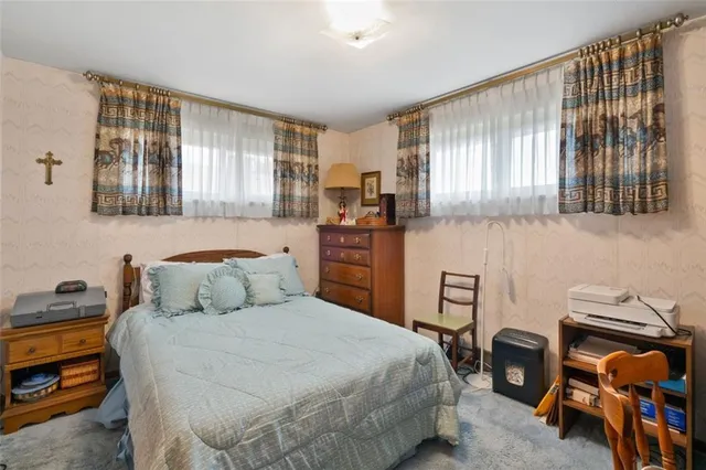 a bedroom with a bed and a tv