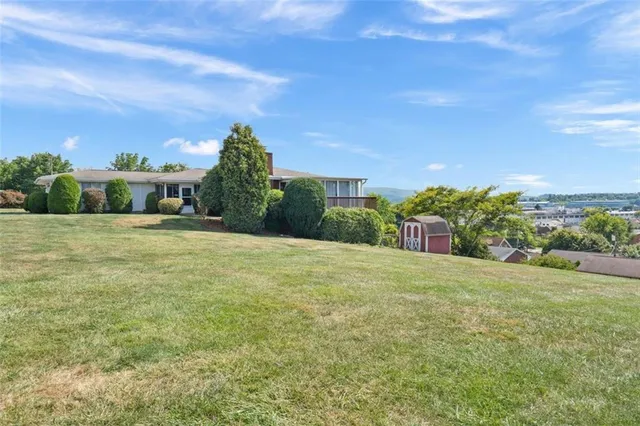 a view of a field with ocean view