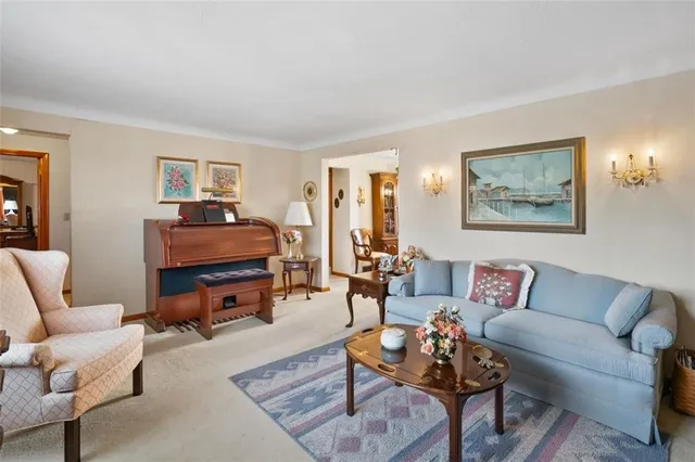 a living room with furniture a rug and a window
