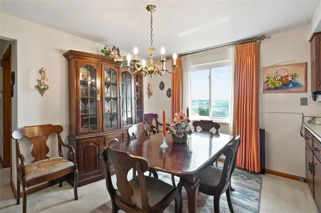 a dining room with furniture a chandelier and window