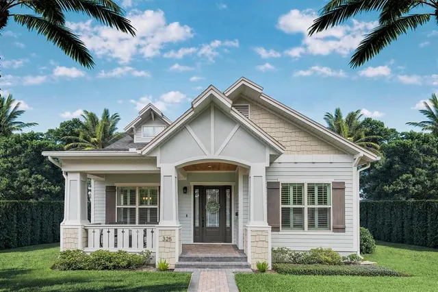 a view of a white house with a small yard plants and palm trees