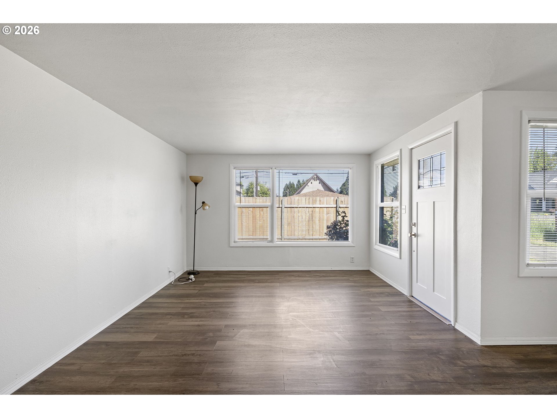 1008 Coburg Road Eugene, OR 97401 - Photo 6 of 46 a view of an empty room with wooden floor and a window