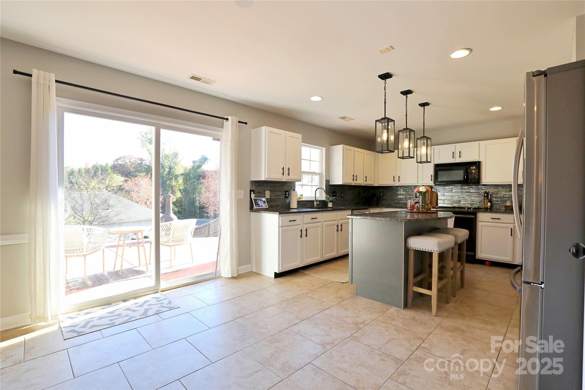 9010 Pembroke Court Fort Mill, SC 29707 - Photo 13 of 29 a kitchen with kitchen island granite countertop a counter top space appliances and a counter top space