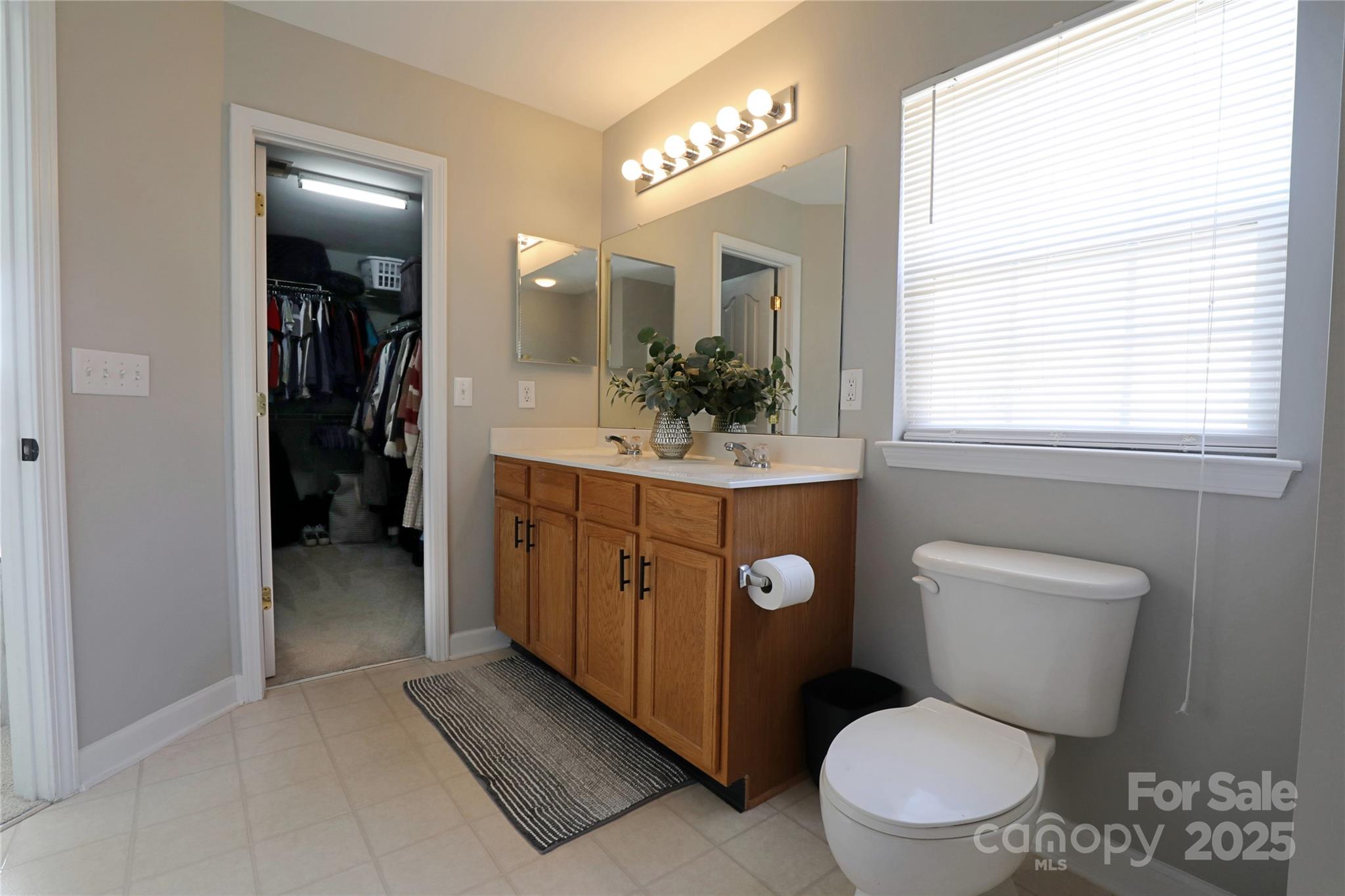 9010 Pembroke Court Fort Mill, SC 29707 - Photo 18 of 29 a bathroom with a toilet sink and mirror