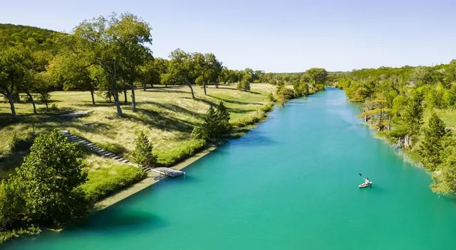 a view of a golf course with the lake