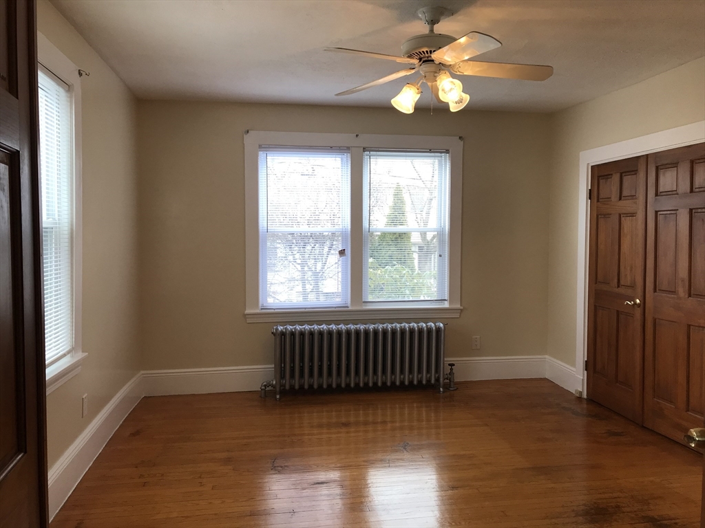 63 Montclair Avenue, Unit 1 Quincy, MA 02171 - Photo 1 of 11 a view of an empty room with window and wooden floor