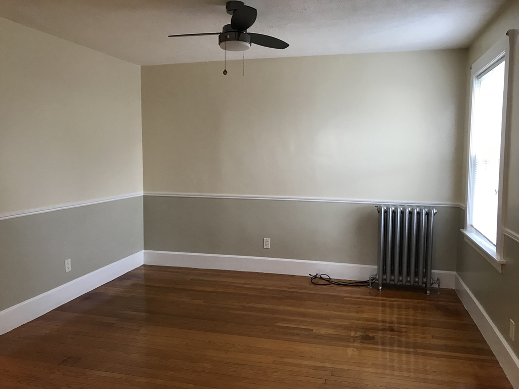63 Montclair Avenue, Unit 1 Quincy, MA 02171 - Photo 2 of 11 wooden floor in an empty room with a window