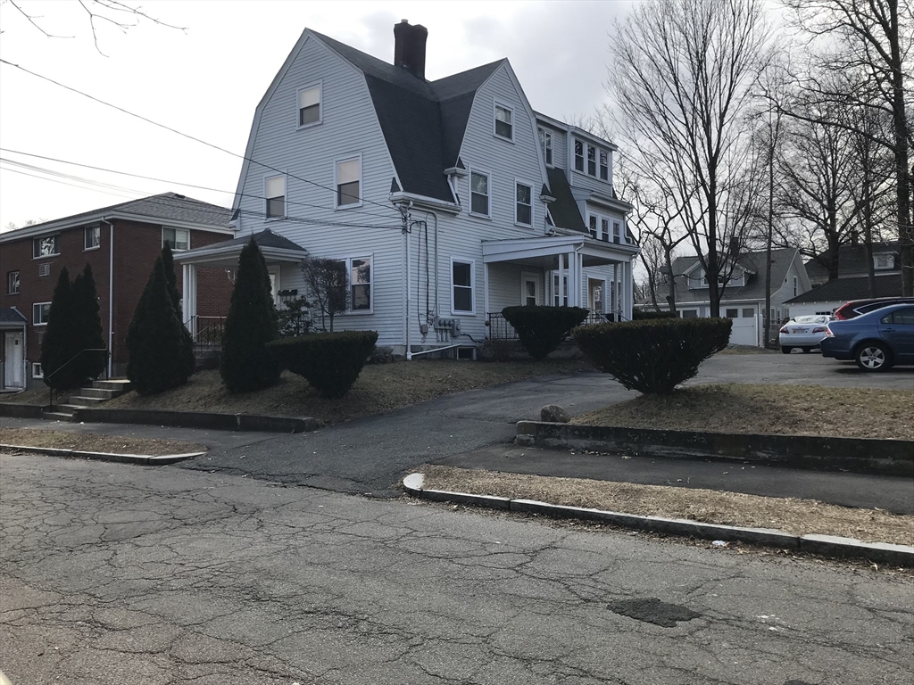 63 Montclair Avenue, Unit 1 Quincy, MA 02171 - Photo 10 of 11 a view of a white house with a large tree