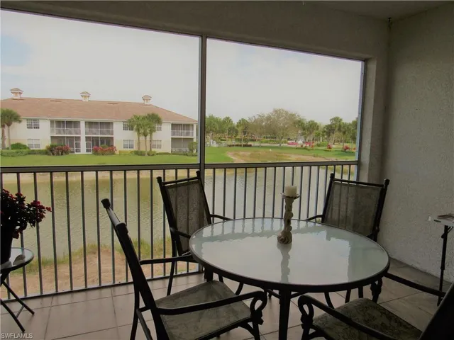 a view of a balcony with furniture and wooden floor