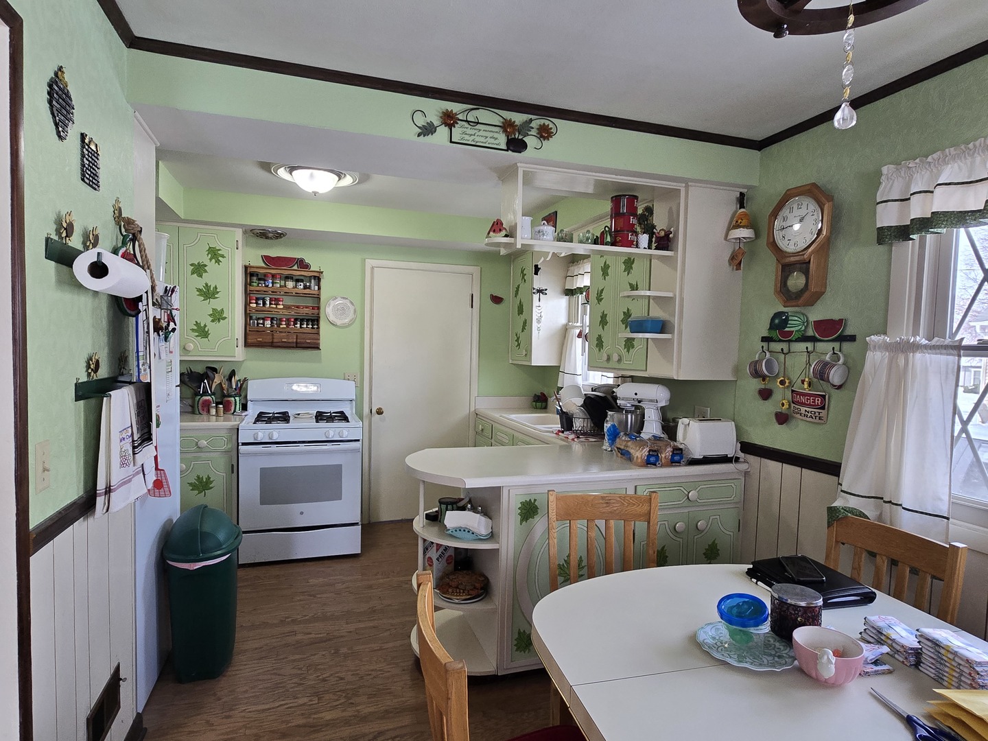 1408 South 10th Street Clinton, IA 52732 - Photo 4 of 10 a kitchen with a refrigerator and a stove top oven