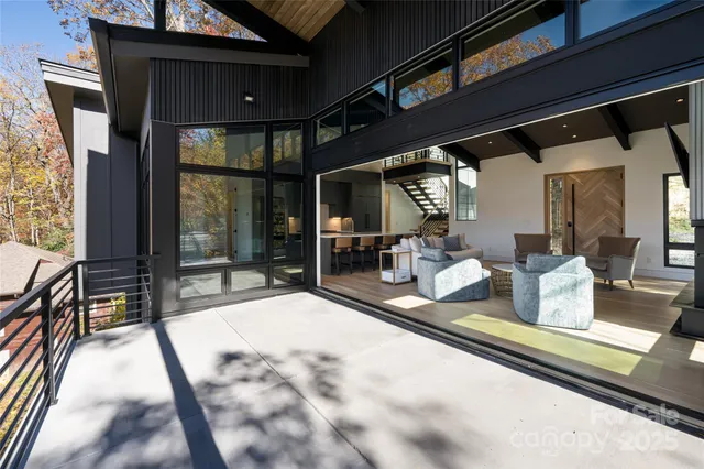 a dining hall with stainless steel appliances kitchen island a table and chairs in it