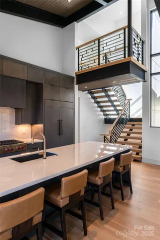 a kitchen with stainless steel appliances a stove a sink and cabinets