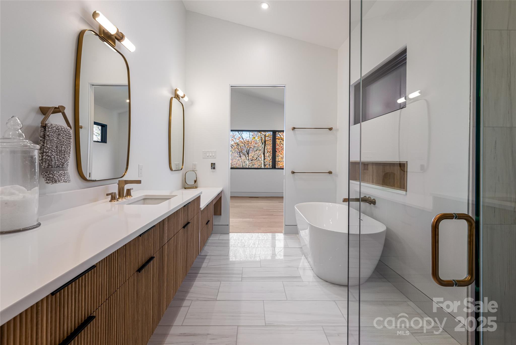 371 Oklahoma Road Montreat, NC 28711 - Photo 28 of 48 a spacious bathroom with a double vanity sink a mirror and bathtub