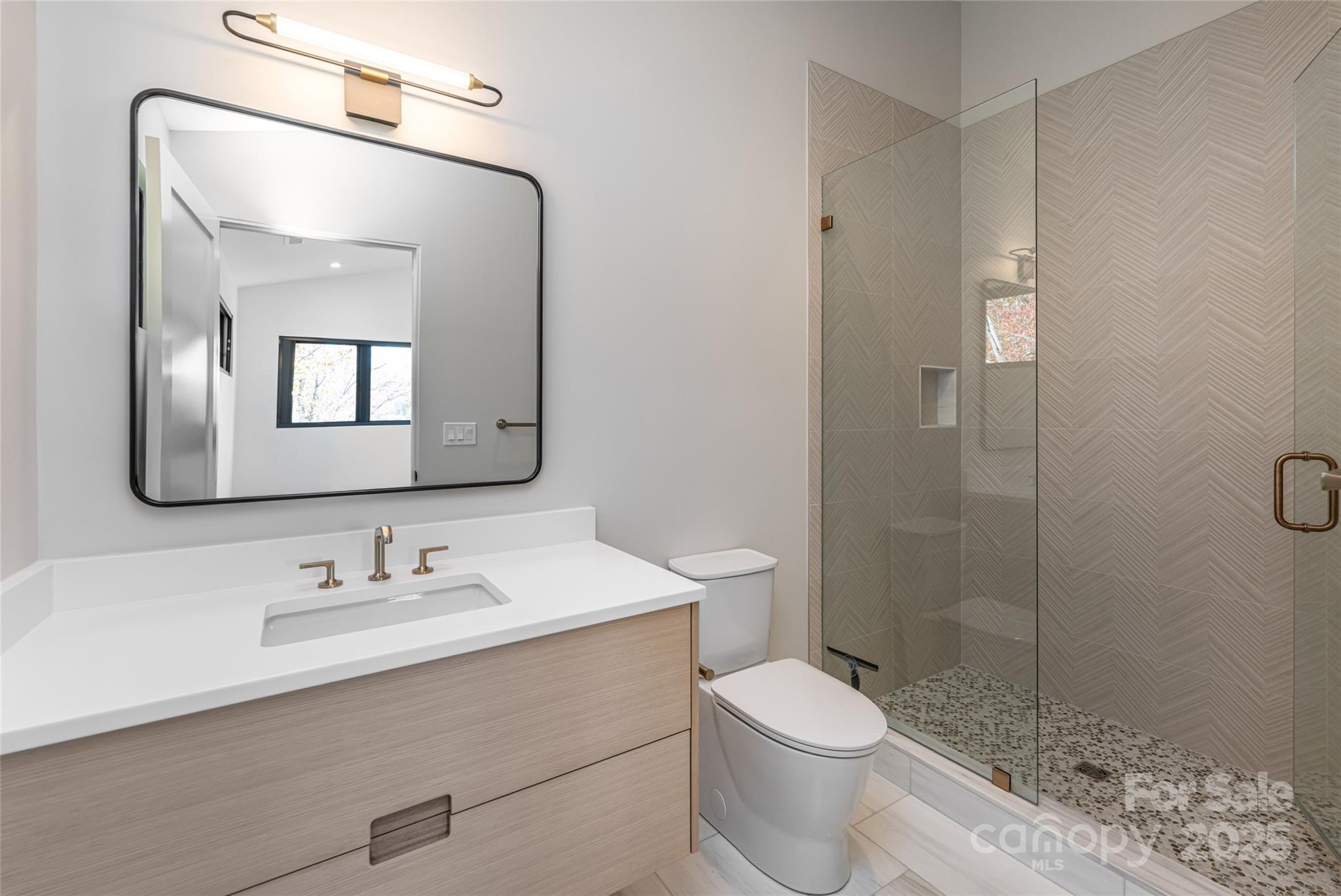 371 Oklahoma Road Montreat, NC 28711 - Photo 32 of 48 a bathroom with a granite countertop toilet sink shower and mirror